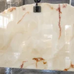 Premium grade Afghan White Onyx slab stacked in warehouse before shipping to international clients
