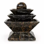 Black & Gold Marble Fountain handcrafted by Pakistan Marble & Onyx featuring a modern three-tier geometric design with a polished marble sphere for luxury gardens, villas, hotels, commercial landscapes, and worldwide export.