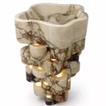 Calacatta Viola marble sculptural wash basin with burgundy veining and illuminated stone pedestal by Pakistan Marble & Onyx