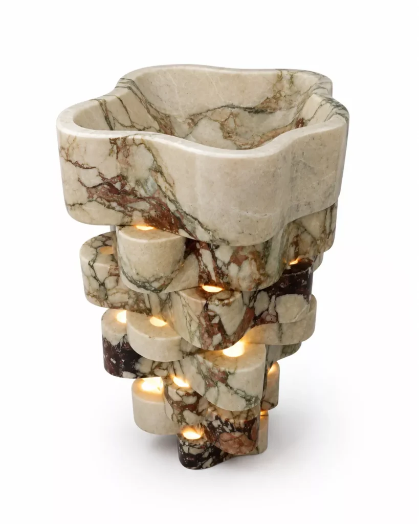Calacatta Viola marble sculptural wash basin with burgundy veining and illuminated stone pedestal by Pakistan Marble & Onyx