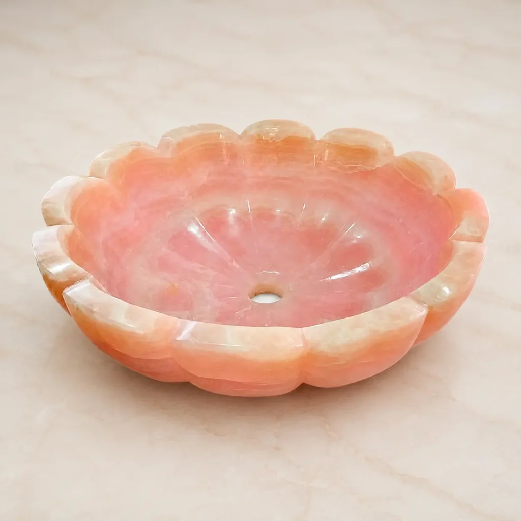 Pink onyx sink handmade in Pakistan with natural rose veining
Polished pink onyx vessel sink by Pakistan Marble & Onyx
Close-up of pink onyx sink showing natural stone veining pattern
Round pink onyx countertop basin in blush and coral tones