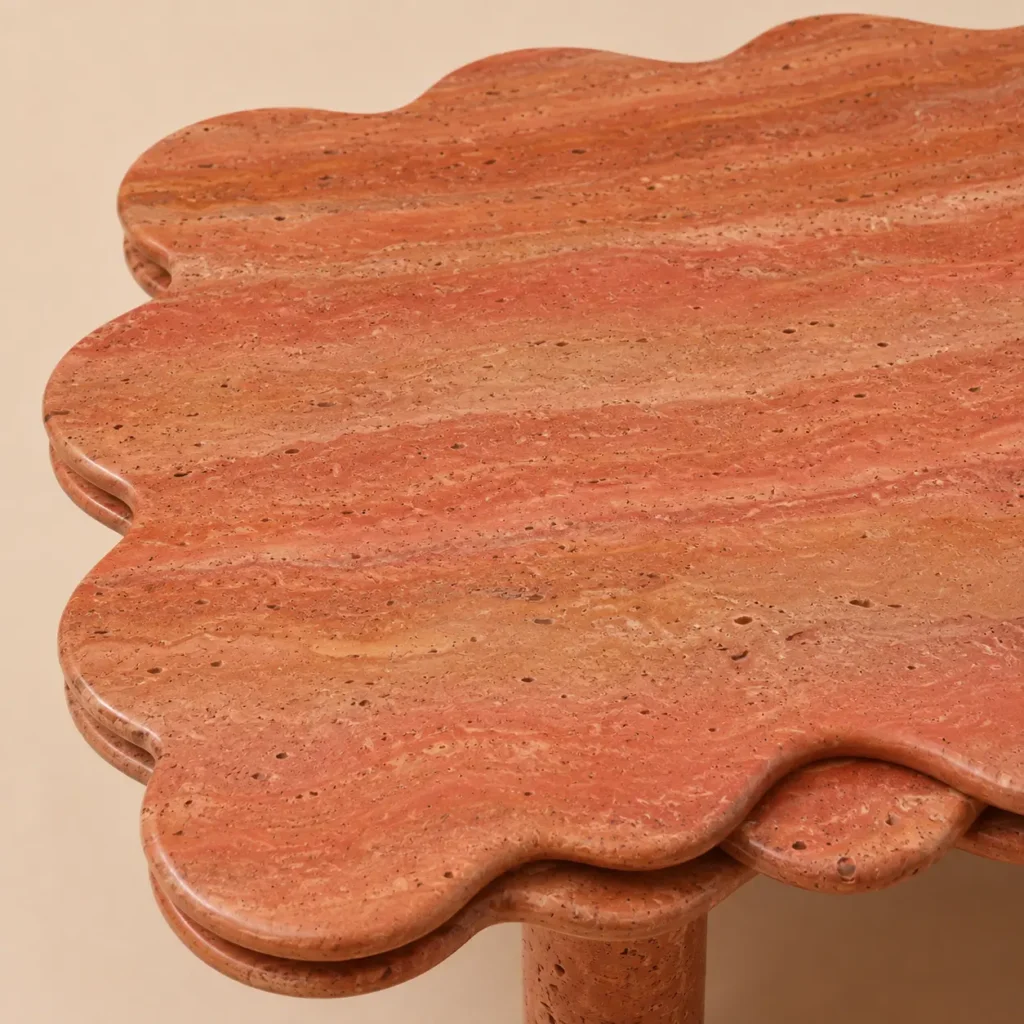 Red travertine marble center table with scalloped edge and cylindrical legs, handcrafted by Pakistan Marble & Onyx